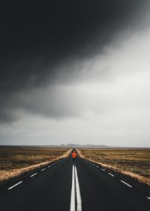 Person running on an open road